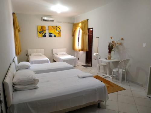 Giường trong phòng chung tại hotel encontro das aguas
