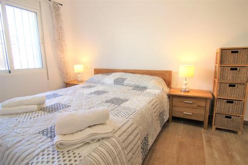 a bedroom with a bed and a desk and a window at A0831 in Calpe
