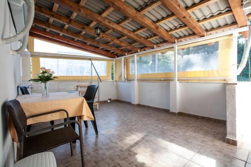 a dining room with a table and some windows at Apartment Boras Lux in Cavtat