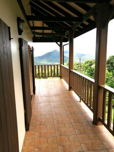 a balcony with a view of the mountains at Trois Piton Apartments in Pont Cassé