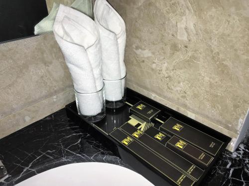 a pair of white high heels and white boots on a table at T&M Luxury Hotel Hanoi in Hanoi