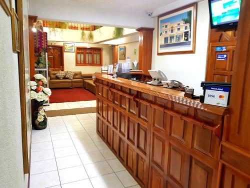 a lobby of a hotel with a reception counter at Hotel Las Americas in Quetzaltenango