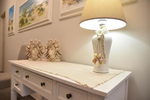 a table with a lamp on top of it at DolceLina Home in Lampedusa