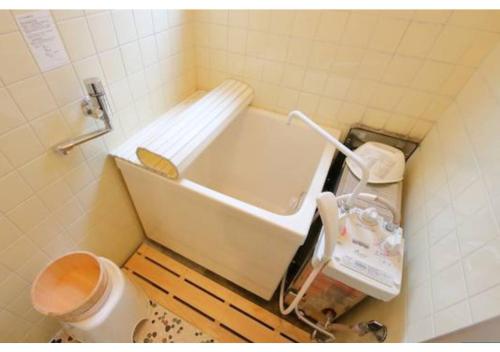 a small bathroom with a toilet and a bath tub at Daihan Building / Vacation STAY 3304 in Osaka