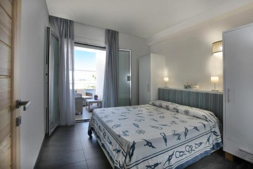 a bedroom with a bed and a large window at Casa Vacanze Sopravento in Porto Cesareo