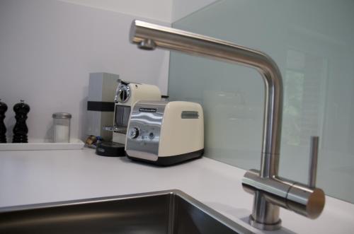 a kitchen counter with a sink and a coffee maker at Apartment Maria Detmold in Detmold