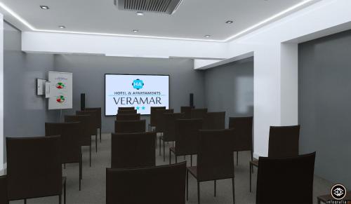 a room with chairs and a projection screen at Veramar Aparthotel in Fuengirola