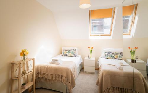 A bed or beds in a room at St Sidwells Townhouses'