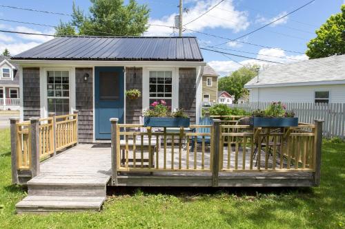 a house with a wooden deck with potted plants on it at Seaside Beach Resort in Saint Andrews