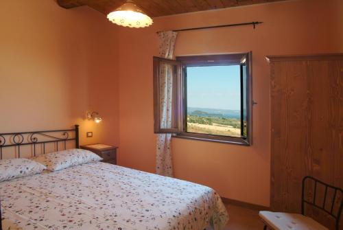 una camera con letto e finestra di Agriturismo Le Ginestre a Capodimonte