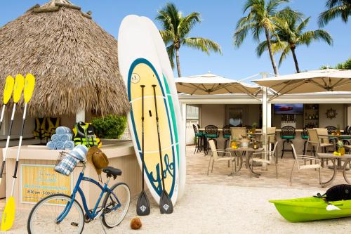 a surfboard and a bike parked next to a restaurant at Sanibel Inn in Sanibel