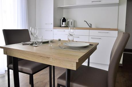 drewniany stół z kieliszkami do wina w kuchni w obiekcie rent-my-apartment w mieście Rietheim-Weilheim