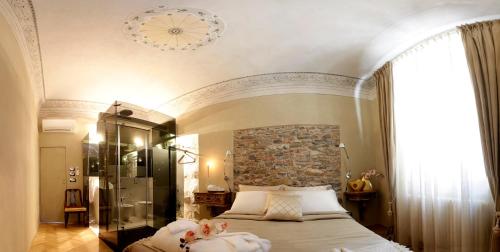 a bedroom with a bed with two stuffed animals on it at Residenza D'Epoca -Santa Caterina in Pisa