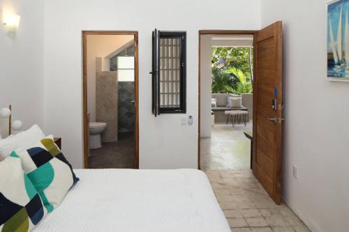 a bedroom with a bed and a door leading to a patio at Villa Dorado B in Sayulita