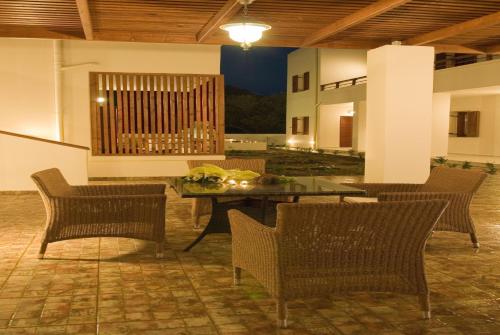 a patio with chairs and a table and a table and chairsktop at Syia Hotel in Sougia
