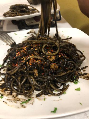 a pile of noodles on a plate with a fork at ALBA DEL CAPO in Palermo