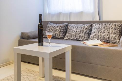 a bottle of wine on a table next to a couch at Haus Stepcich in Plomin