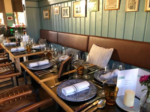 a table in a restaurant with plates and glasses at Hafen 17 Hotel Küche Bar in Kehl am Rhein