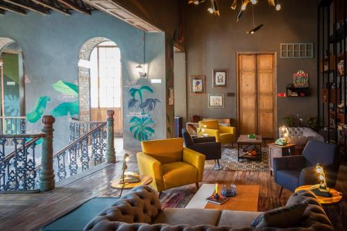 a living room filled with furniture and a fire place at Selina La Candelaria Bogotá in Bogotá