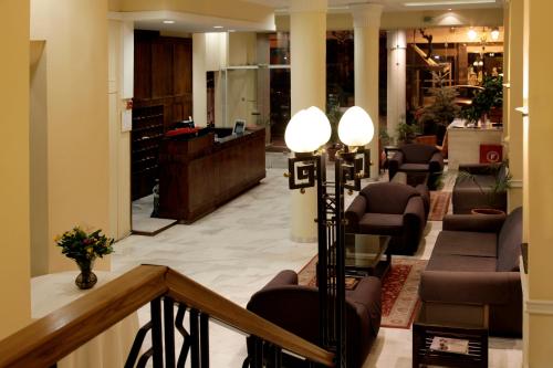 a lobby with a waiting area with chairs and a desk at Pella in Thessaloniki