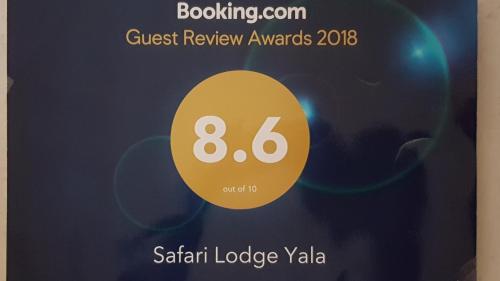 a poster for the quest review awards with a yellow number at Safari Lodge Yala in Kataragama