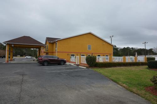 a car parked in a parking lot in front of a building at Jameson Inn and Suites Hazelhurst in Hazlehurst