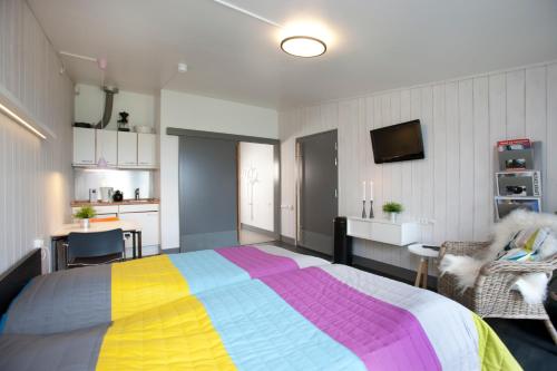 a bedroom with a bed with a colorful blanket at Musholm Holiday, Sport & Conference in Korsør
