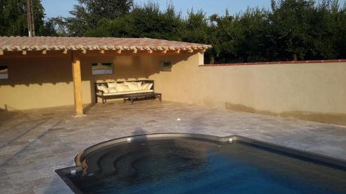 a swimming pool in the middle of a patio at Gîte de Beausoleil in La Romieu