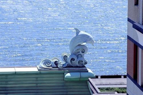 a statue on top of a building next to the water at Hotel Okura Tokyo Bay in Urayasu