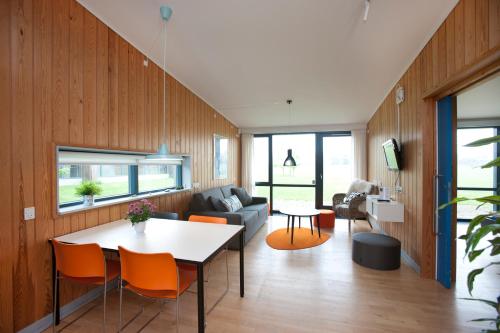 a living room with a table and a couch at Musholm Holiday, Sport & Conference in Korsør