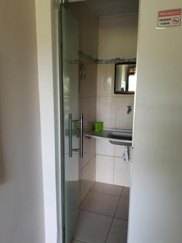 a small bathroom with a sink and a shower at Pousada Tulum in Barra Grande