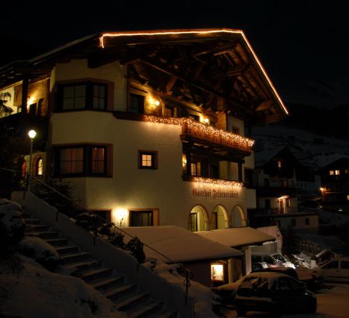 a large building with lights on top of it at night at Hotel Felsenstüberl in Sölden