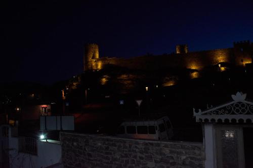 a castle is lit up at night at Light House Old City in Akhaltsikhe