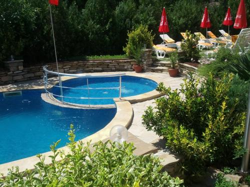 una piscina con un columpio en un patio en Byala Perla Family Hotel, en Byala