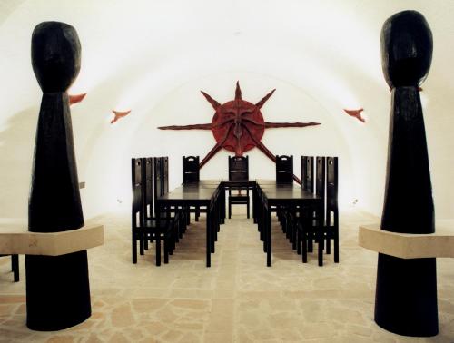 a dining room with a black table and black chairs at Hotel Marcincak*** in Mikulov