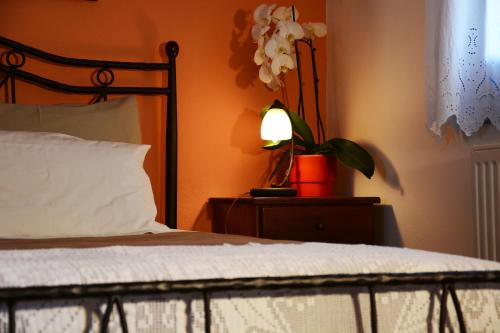 a bedroom with a bed with a lamp and a plant at Dolphin Studios in Astypalaia Town