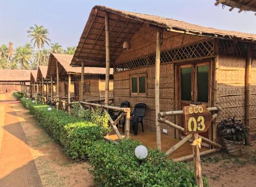 a house with a sign in front of it at Beach Street Eco Resort - Mandrem in Mandrem