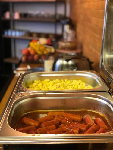 a buffet with two trays of food on a table at Hotel Diamante in Sao Paulo
