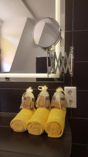 a bathroom with yellow towels on a black counter at Villa Renatus in Obernburg am Main