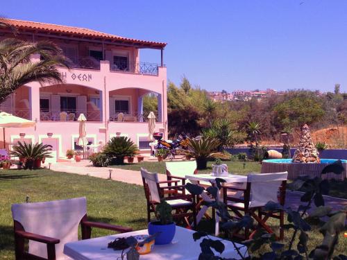 a house with tables and chairs in front of it at Land of Gods in Gythio