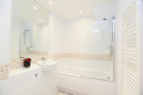 a white bathroom with a sink and a shower at The Avenue in Leamington Spa