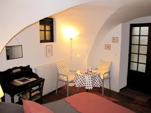a living room with a table and chairs at La Chambre d'Hôtes du Cladan in LʼÉpine
