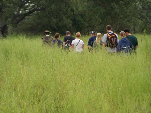 a large group of people standing in a field at Thornhill Safari Lodge in Guernsey Nature Reserve