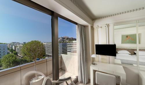Télévision ou salle de divertissement dans l'établissement NJV Athens Plaza