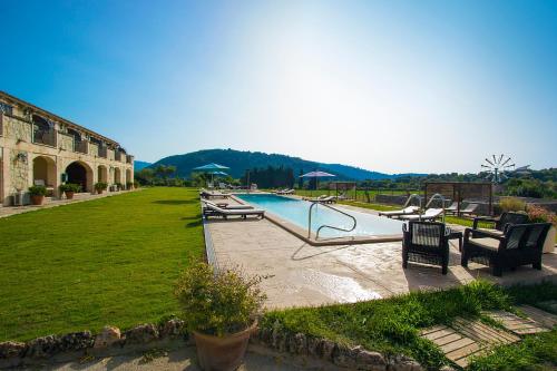 a swimming pool in a yard next to a building at Monnaber Nou Finca Hotel & Spa in Campanet