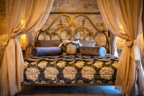 a bedroom with a large bed with curtains at Achtis Hotel in Afitos
