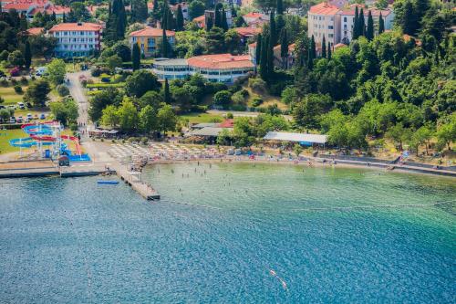 a beach with a bunch of people in the water at Hotel Haliaetum - San Simon Resort in Izola