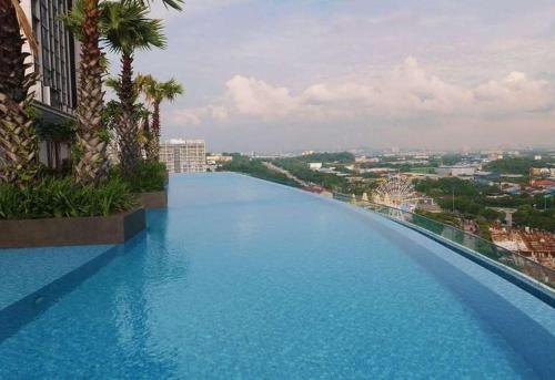 a large swimming pool on top of a building at Halal Islam Tamu iCity Shah Alam in Shah Alam