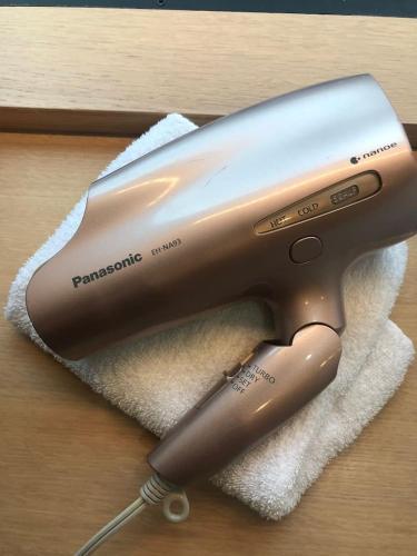 a hair dryer on top of a white towel at Oku-Shibu Residence in Tokyo
