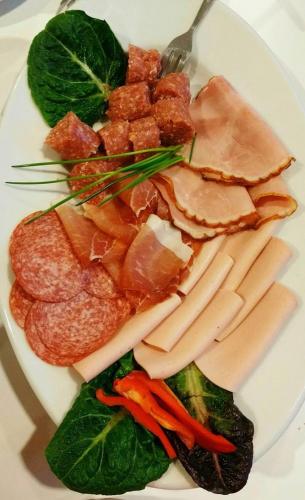 a plate of food with meat and vegetables on it at Jugendherberge Friedrichstadt in Friedrichstadt